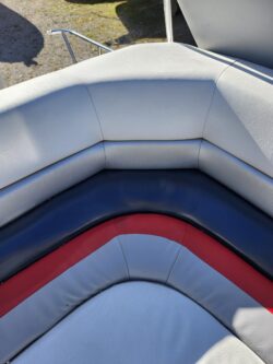 Blue and white marine vinyl boat seat after professional repair