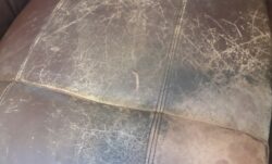 Close-up of worn leather before restoration